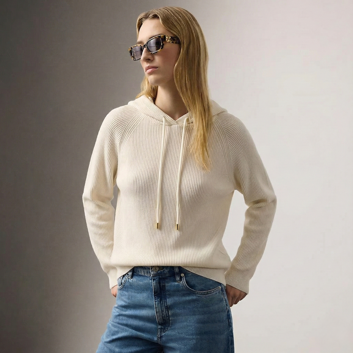 Cream-colored Claudia cashmere hoodie for women by Christine Brewer, featuring a cozy, relaxed fit and soft knit texture.
