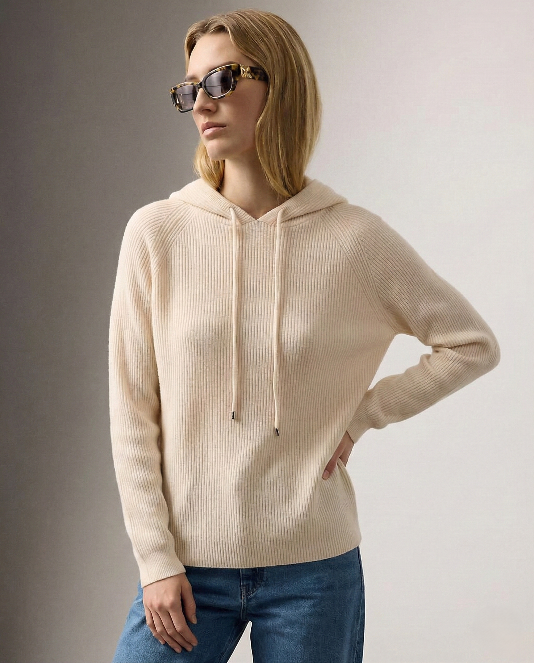 Cream-colored Claudia cashmere hoodie for women by Christine Brewer, shown on a model with a relaxed fit and soft fabric.