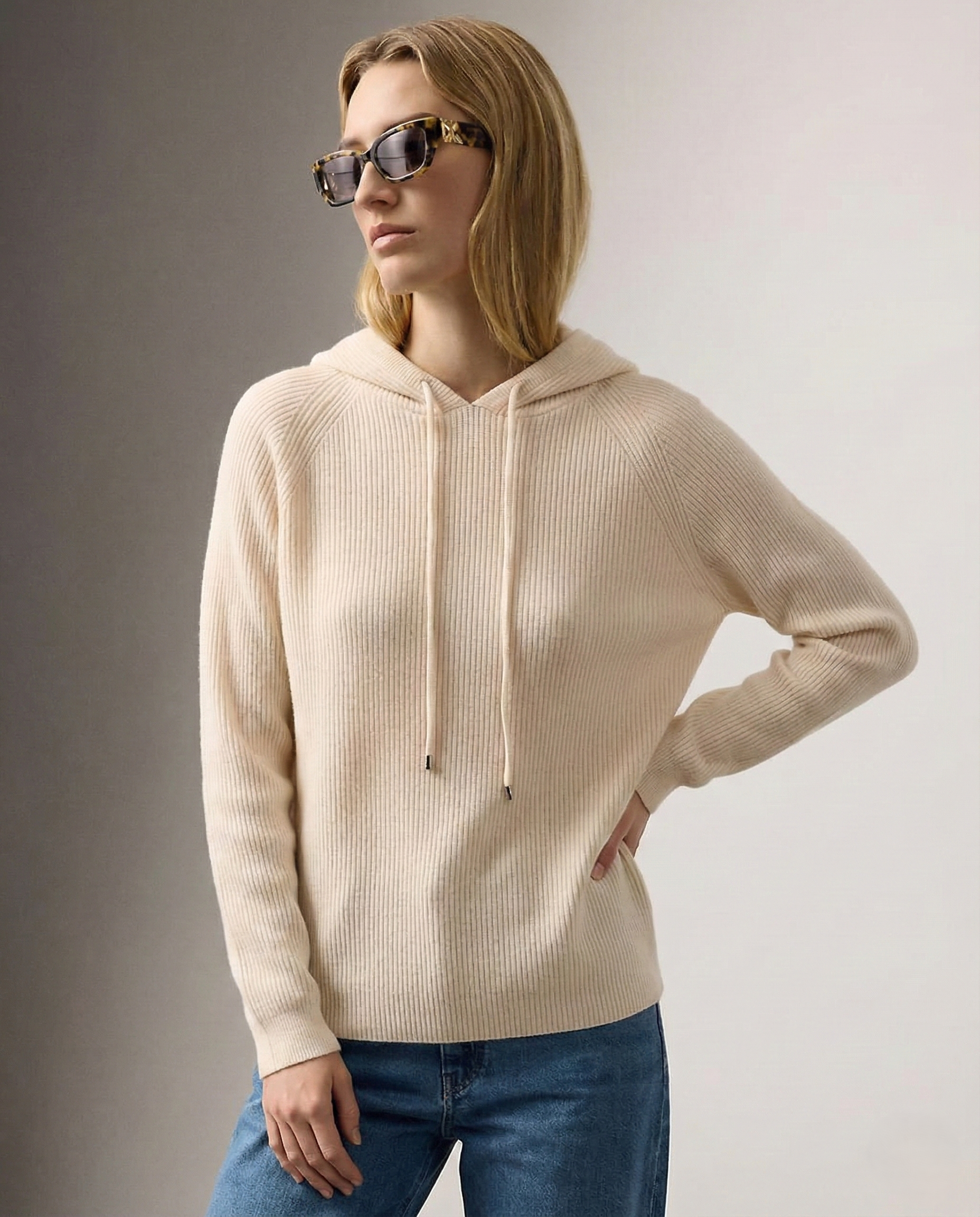 Cream-colored Claudia cashmere hoodie for women by Christine Brewer, shown on a model with a relaxed fit and soft fabric.