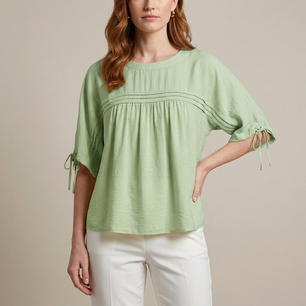 Green linen summer blouse for women by Christine Brewer, flowy top with a relaxed fit and lightweight fabric.