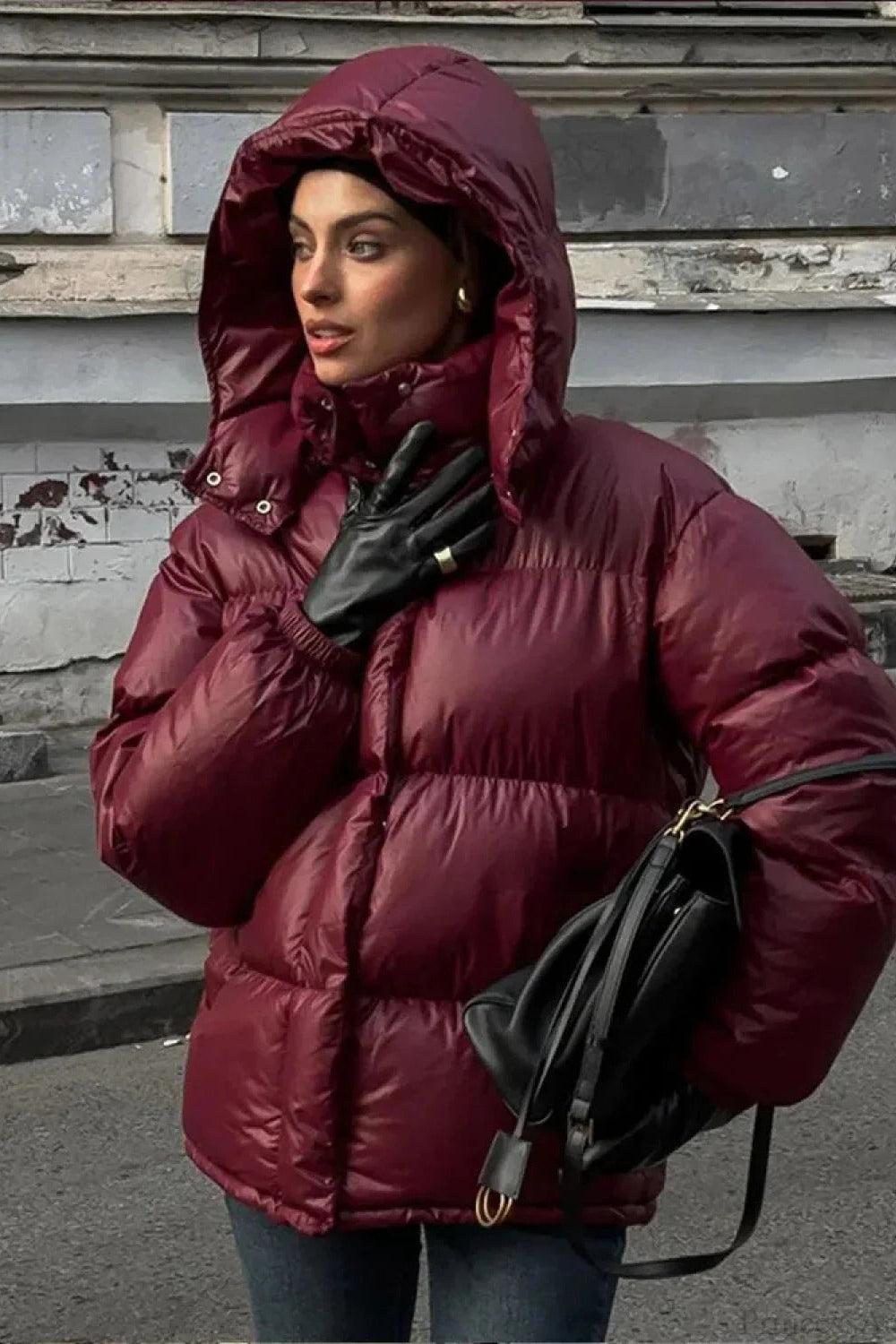 Black Delilah hooded quilted puffer jacket for women by Christine Brewer, featuring insulated warmth and stylish design.