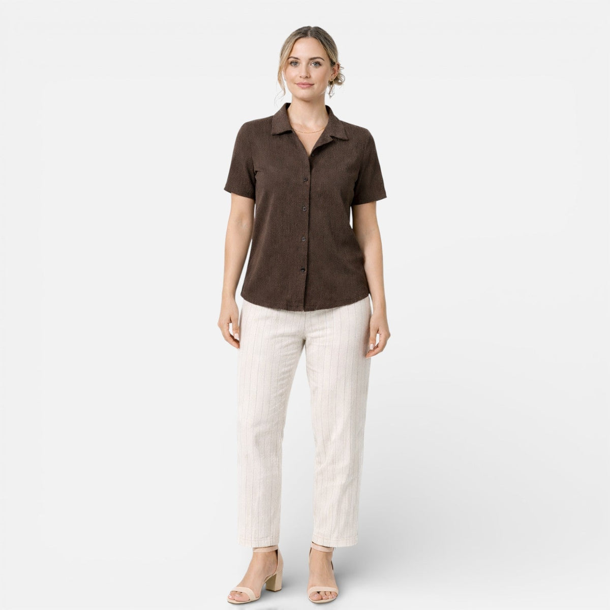 Women's short sleeve button-up shirt by Christine Brewer, classic design with a fitted collar and stylish button details.