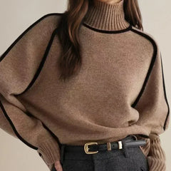 Brown oversized turtleneck sweater by Christine Brewer with luxe wool edge trim, perfect for autumn, styled casually.