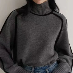 Black oversized turtleneck sweater by Christine Brewer featuring luxe wool edge trim, perfect for autumn casual and cozy wear.