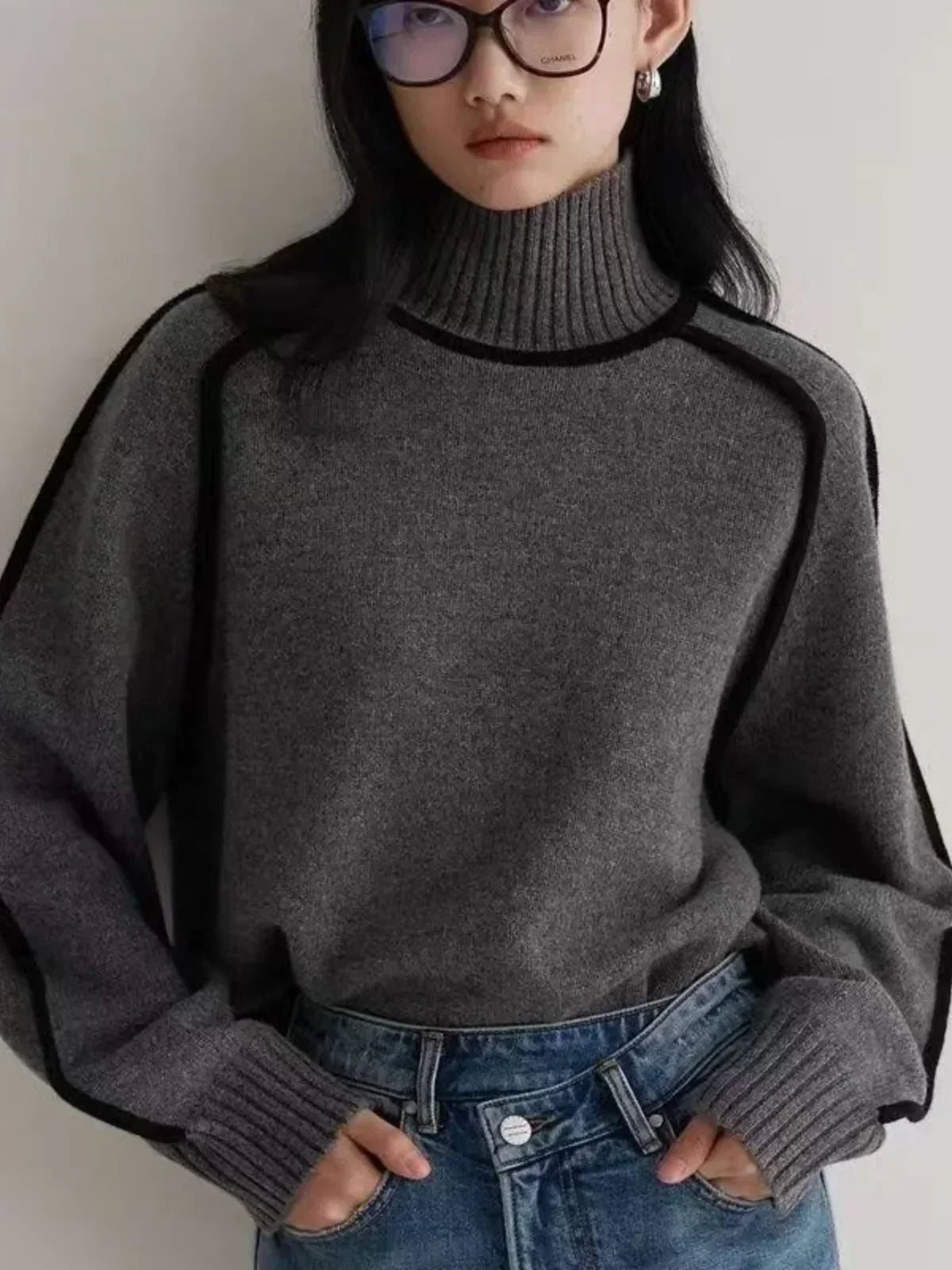 Black oversized turtleneck sweater by Christine Brewer featuring luxe wool edge trim, perfect for autumn casual and cozy wear.
