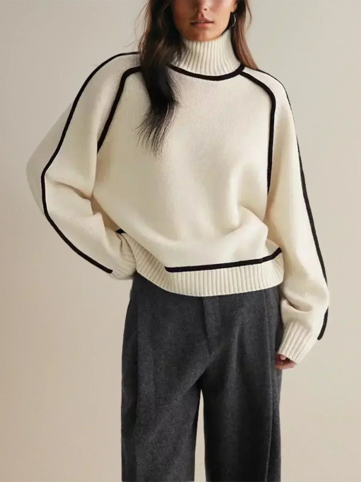 White oversized turtleneck sweater with wool edge trim, designed by Christine Brewer, perfect for autumn comfort and style.