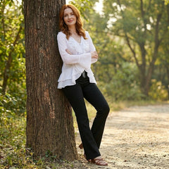 Women’s summer blouse by Christine Brewer with bell sleeves, made of denim, styled casually in a lifestyle setting.