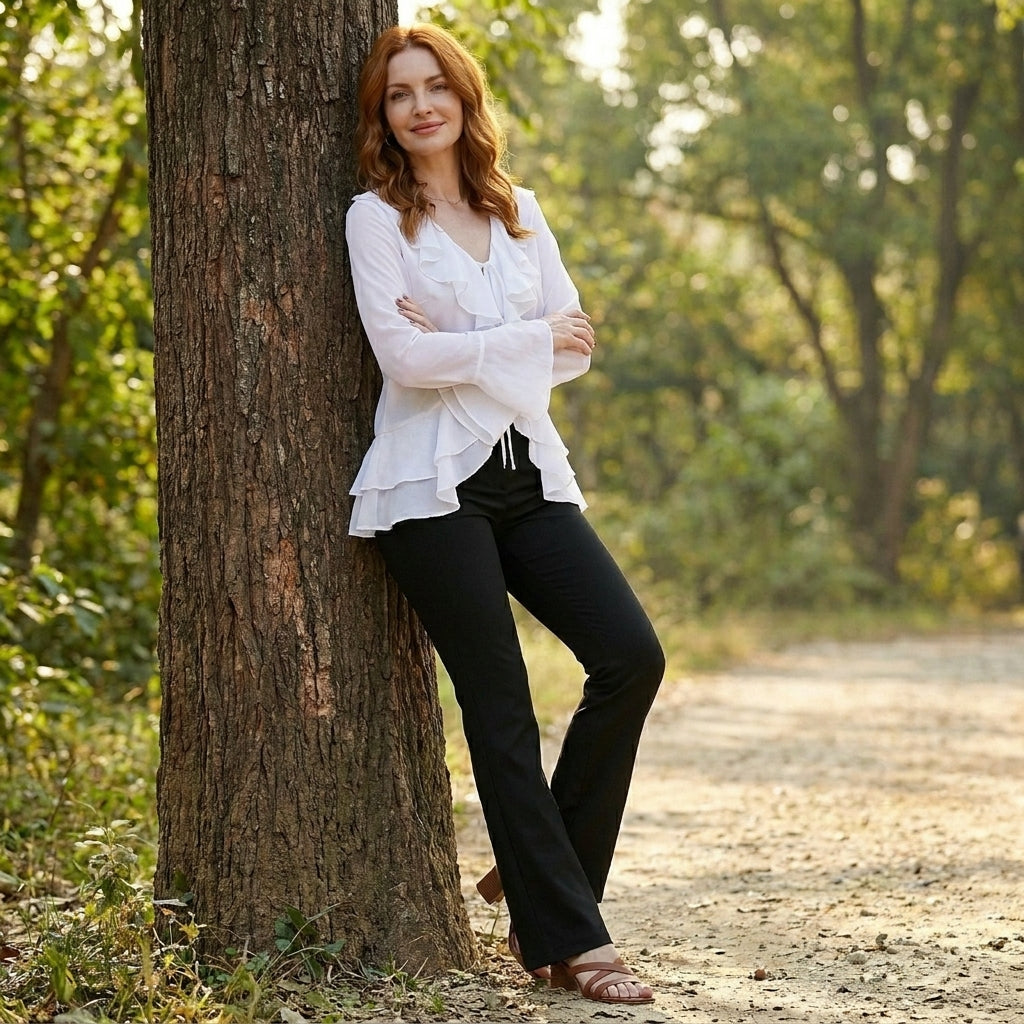 Women’s summer blouse by Christine Brewer with bell sleeves, made of denim, styled casually in a lifestyle setting.
