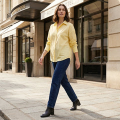 Women’s linen summer top by Christine Brewer, button-front blouse styled for casual wear, shown in a lifestyle setting.