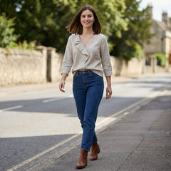 Women’s summer blouse by Christine Brewer featuring a V-neck denim design with ruffle details, styled for casual summer wear.