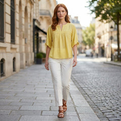 Women’s summer linen blouse by Christine Brewer, flowing and lightweight, worn casually outdoors with a relaxed fit and natural fabric.