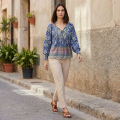 Women's floral long sleeve linen summer blouse by Christine Brewer, shown styled with casual accessories.