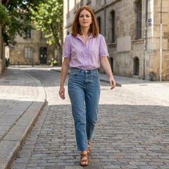 Women’s summer blouse by Christine Brewer featuring a V-neck, short sleeves, and lace details, styled in a casual outdoor setting.
