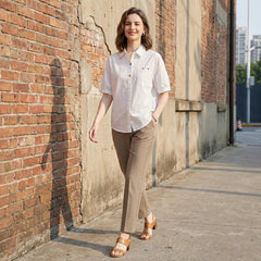 Casual summer women's blouse with puff sleeves, denim fabric, and button front by Christine Brewer, styled with a relaxed fit.