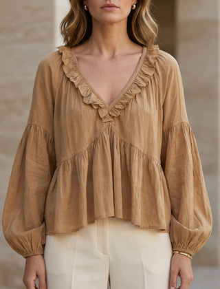 Light brown women's summer blouse with v-neck, long sleeves, and denim ruffle detail by Christine Brewer.