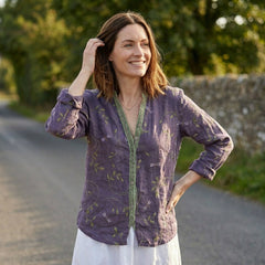 Women's floral V-neck summer blouse by Christine Brewer featuring long sleeves and linen fabric, worn by a model.