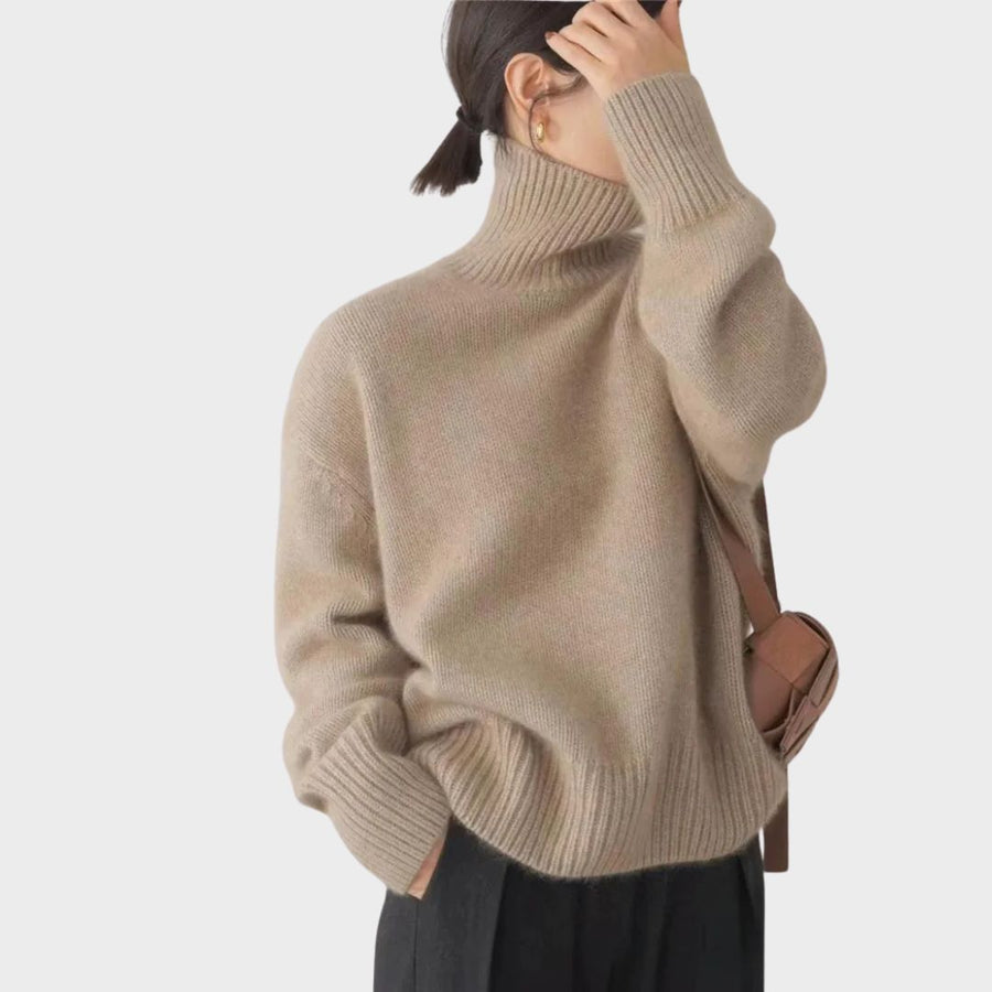 Nienke Huiswerk wearing the Christine Brewer Kennedy high neck sweater for women, featuring a cozy knit in neutral tones.