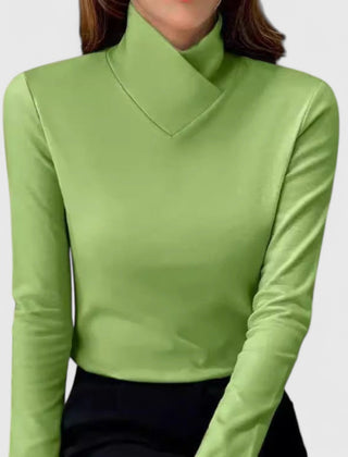 Christine Brewer Elena women's turtleneck sweater, soft knit fabric, fitted style, in a neutral color, displayed on a hanger.