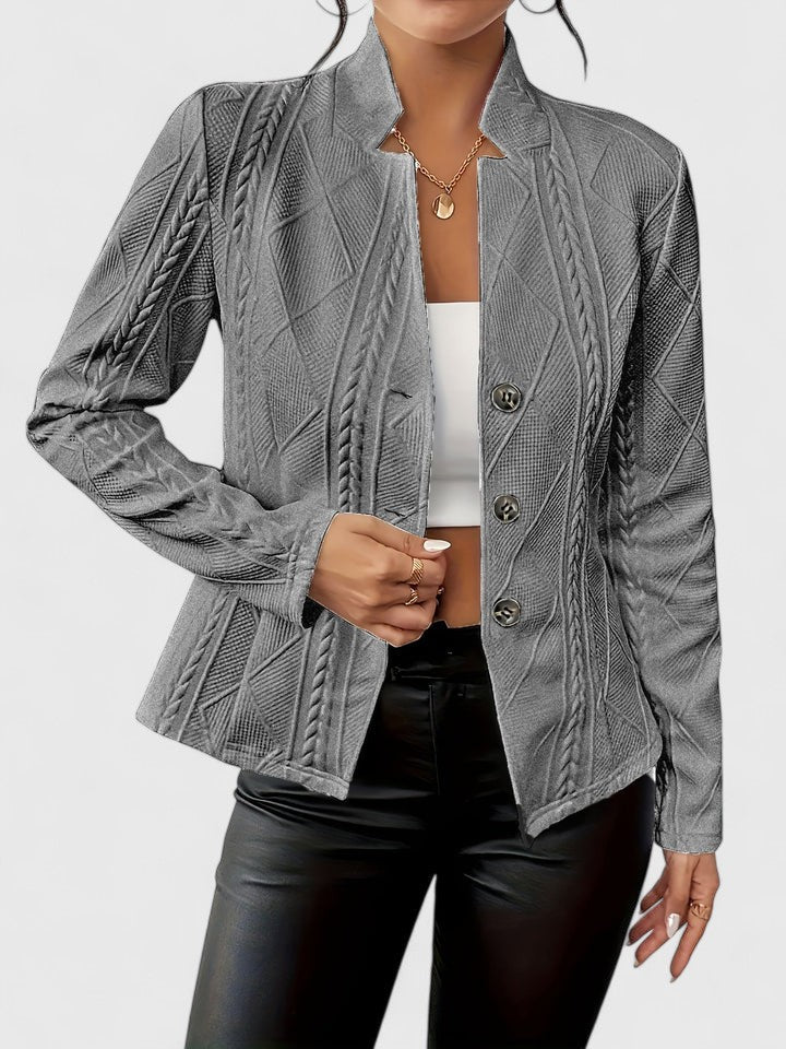 Elegant Christine Brewer Maurelle jacket on a hanger showcasing its tailored fit and classic design.