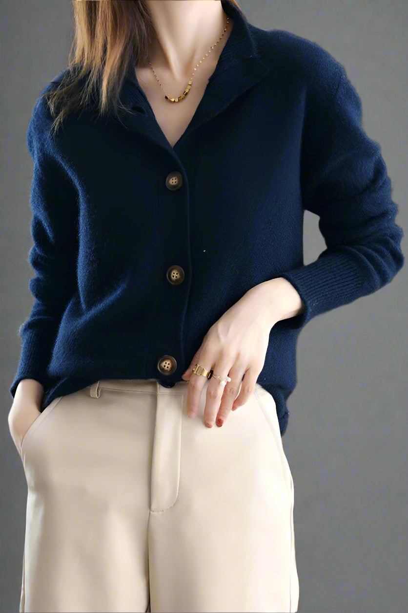 Christina women's cashmere high neck cardigan by Christine Brewer, soft beige color, close-up of cozy knit fabric and high neckline.