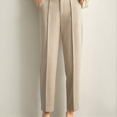 Women's wool tapered trousers by Christine Brewer, cozy merino knit pants with a tailored fit, shown in a neutral color.