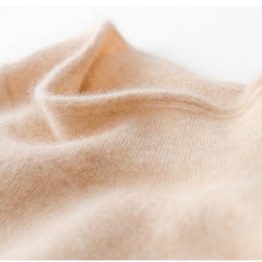 Cream-colored Christine Brewer Gabrielle cashmere turtleneck sweater for women, close-up of soft knit fabric and high neckline.
