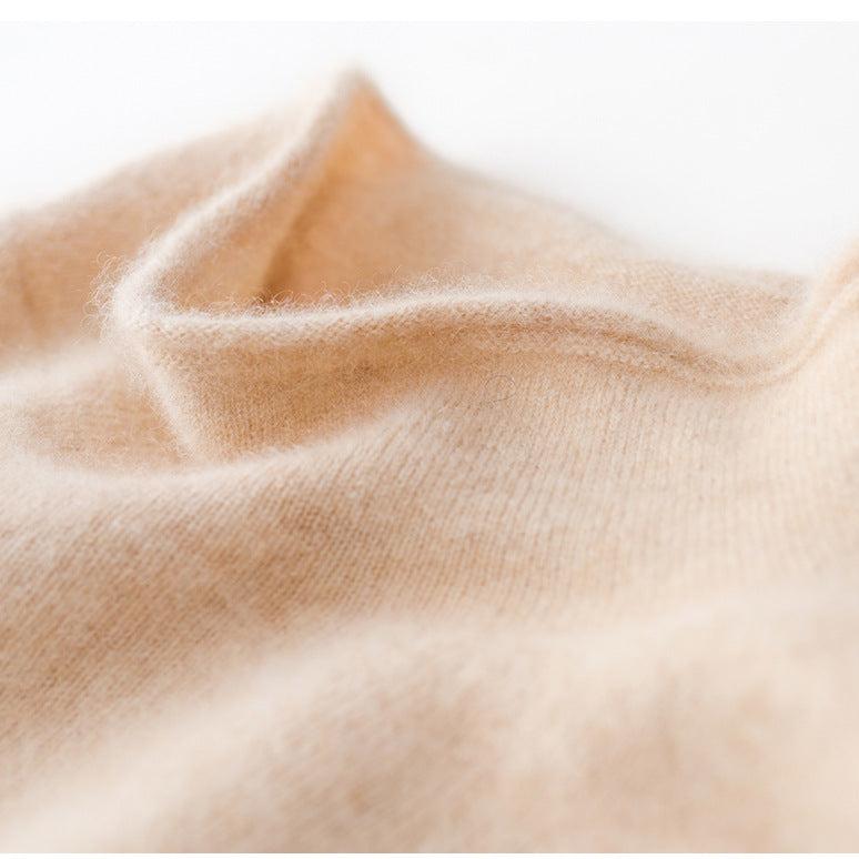 Cream-colored Christine Brewer Gabrielle cashmere turtleneck sweater for women, close-up of soft knit fabric and high neckline.