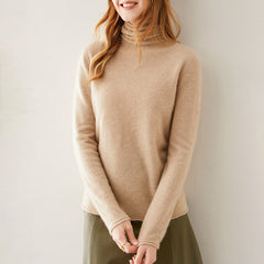 Pink cashmere turtleneck sweater for women by Christine Brewer, featuring a cozy, stylish fit and soft texture.