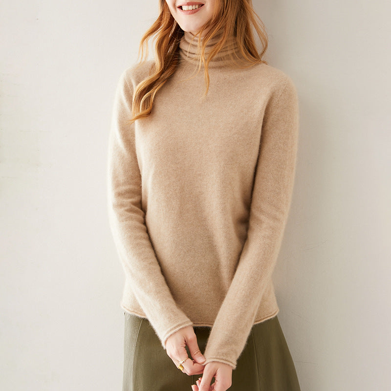 Pink cashmere turtleneck sweater for women by Christine Brewer, featuring a cozy, stylish fit and soft texture.