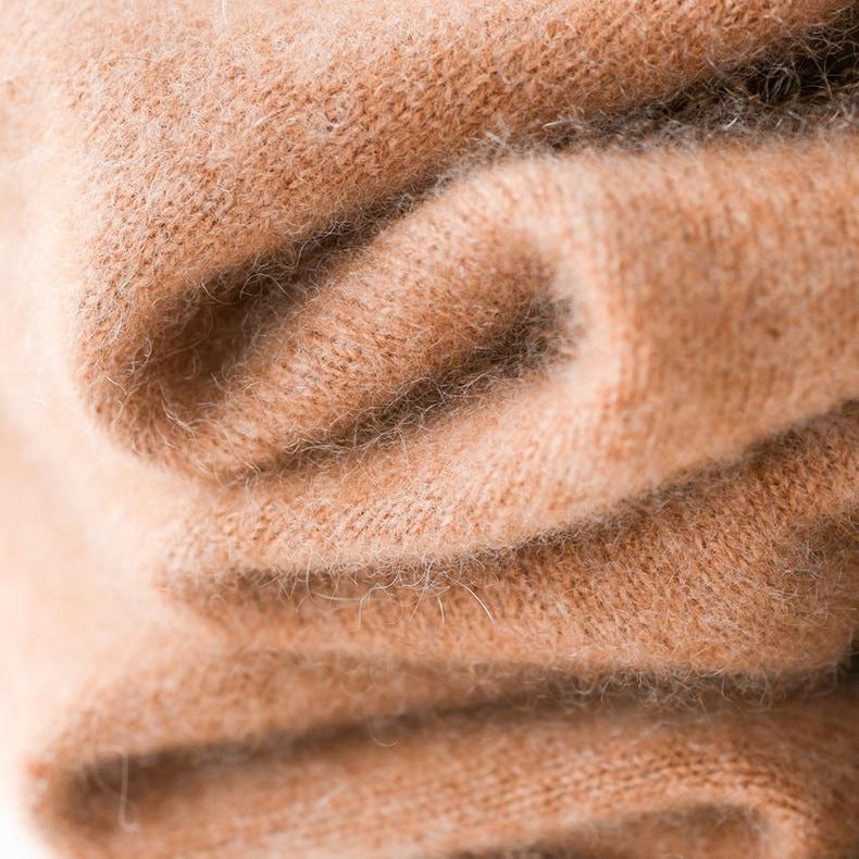Cream-colored Christine Brewer Gabrielle cashmere turtleneck sweater for women, close-up showing soft knit texture.
