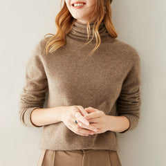 Cream-colored Gabrielle cashmere turtleneck sweater for women by Christine Brewer, soft knit fabric with a cozy fit.