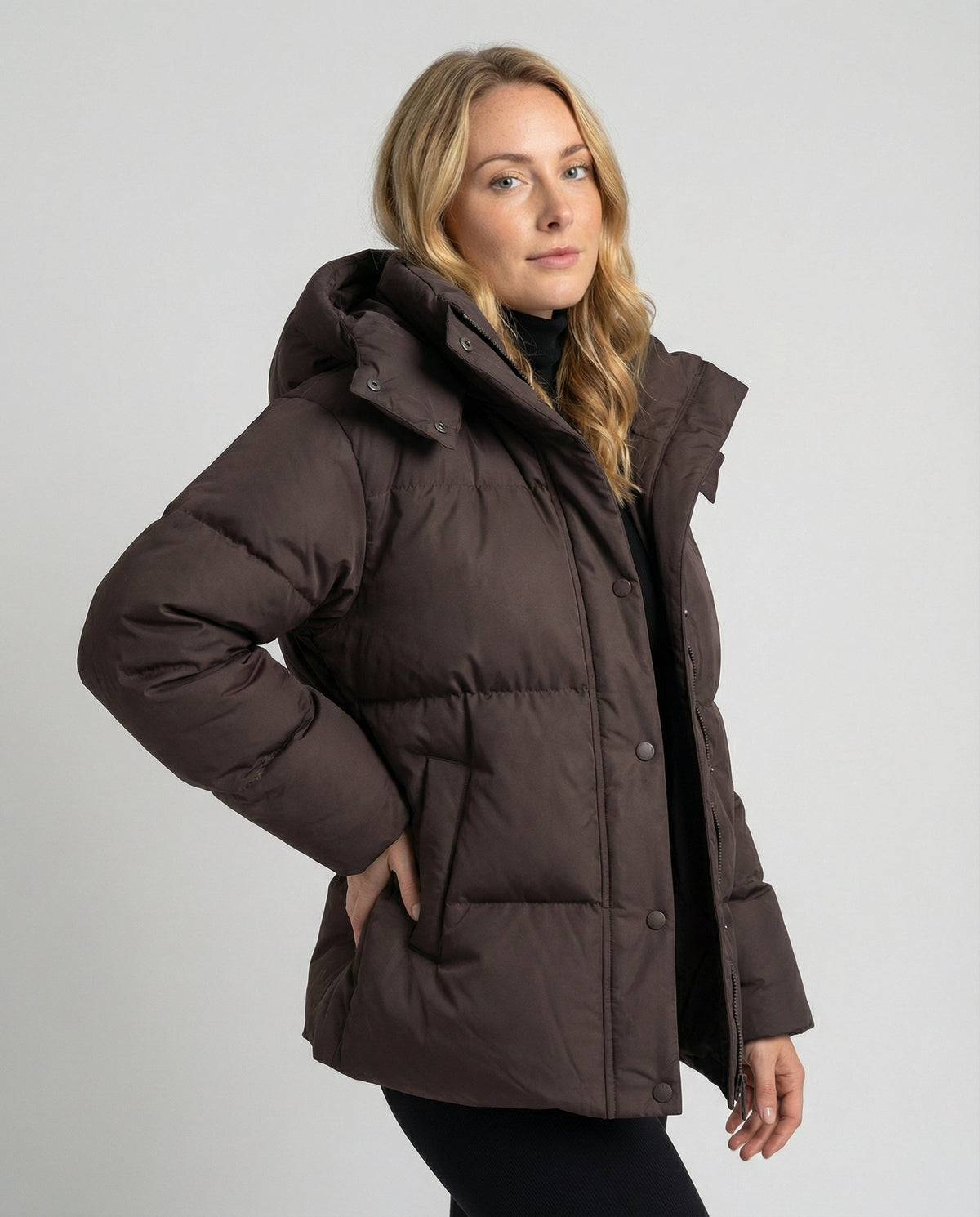 Woman wearing Christine Brewer Penelope oversized puffer jacket, stylish outerwear with a high collar and quilted design.