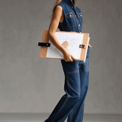 Dark blue denim sleeveless balloon jumpsuit with multiple pockets and wide-leg pants, designed for women by Christine Brewer.