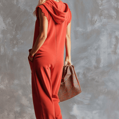 Raspberry red cotton hooded zip-front jumpsuit for women by Christine Brewer, featuring a comfortable fit and stylish design.