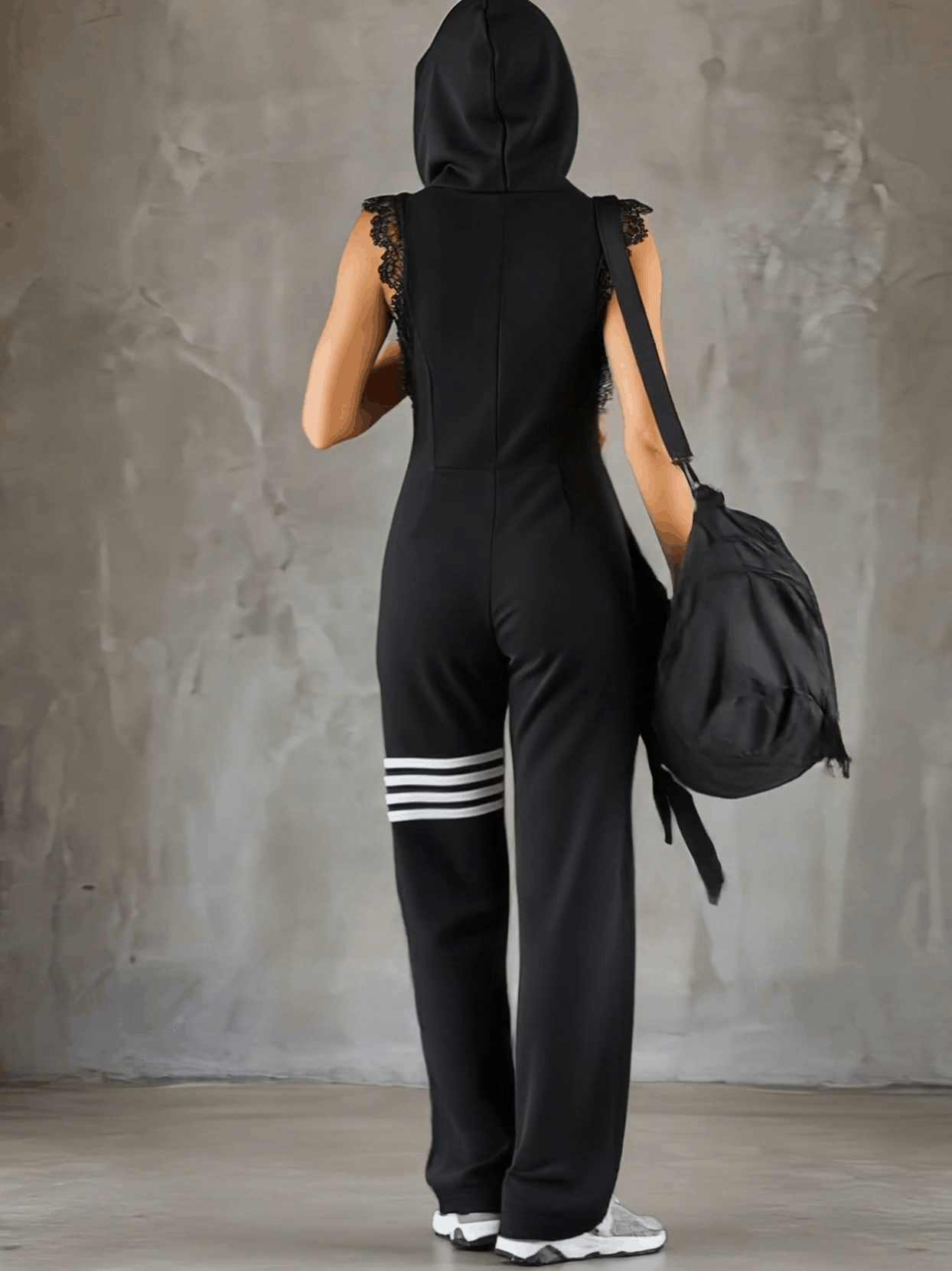Black striped sleeveless hooded jumpsuit for women by Christine Brewer, featuring a stylish fit and casual design.