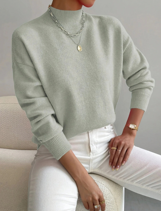 Cream high neck sweater for women by Christine Brewer, featuring a cozy, stylish design with a fitted silhouette.