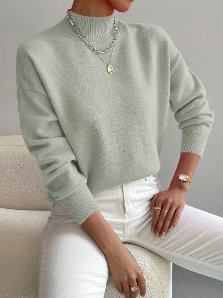 Cream high neck sweater for women by Christine Brewer, featuring a cozy, stylish design with a fitted silhouette.