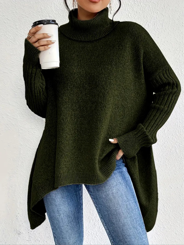 Woman wearing a high neck sweater by Christine Brewer, featuring a cozy, stylish design in a neutral color.