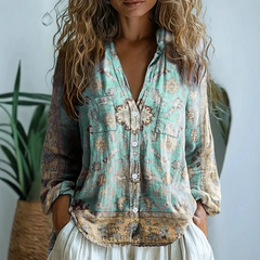Women’s graphic blouse by Christine Brewer featuring a stylish design, shown on a model, perfect for casual or chic outfits.