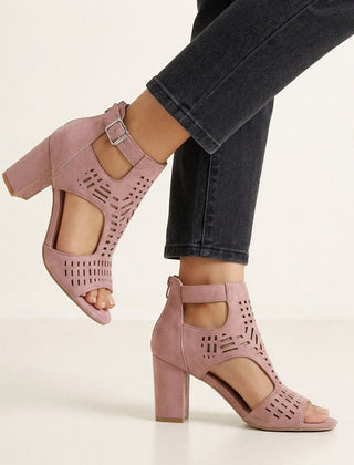 Pink women's block-heel sandals with cut-out design and ankle buckle by Christine Brewer, showcasing stylish open-toe footwear.