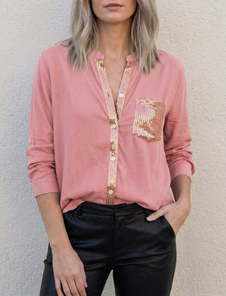 Pink women's summer blouse with V-neck and denim button front, styled as a casual top by Christine Brewer.