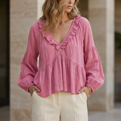 Pink summer women's blouse with V-neck, long sleeves, and ruffle details, by Christine Brewer.