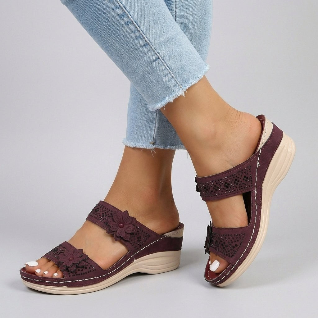 Red floral strap wedge heeled sandals for women by Christine Brewer, featuring a stylish design and comfortable wedge heel.