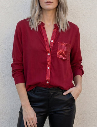 Red women's summer blouse by Christine Brewer featuring a V-neck, denim fabric, and button-front design.