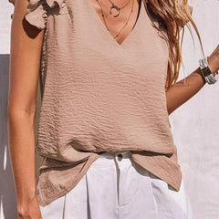 Women's v-neck top with ruffle sleeves by Christine Brewer, shown in a stylish, casual design suitable for everyday wear.