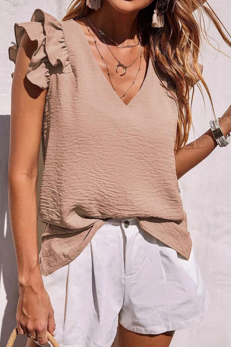 Women's v-neck top with ruffle sleeves by Christine Brewer, shown in a stylish, casual design suitable for everyday wear.