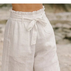 Light beige linen wide-leg trousers for women by Christine Brewer, featuring a loose pull-on style and relaxed fit.