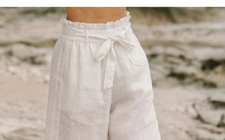 Light beige linen wide-leg trousers for women by Christine Brewer, featuring a loose pull-on style and relaxed fit.