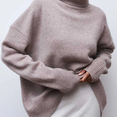 Cream-colored Erica oversized turtleneck sweater for women by Christine Brewer, featuring a cozy, chunky knit design.