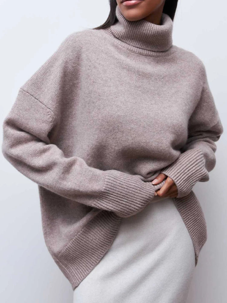 Cream-colored Erica oversized turtleneck sweater for women by Christine Brewer, featuring a cozy, chunky knit design.